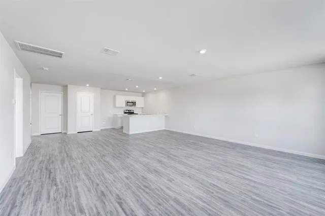 a view of a kitchen with wooden floor and kitchen