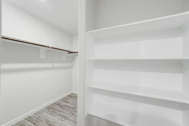 a bathroom with a bathtub shower sink vanity and toilet