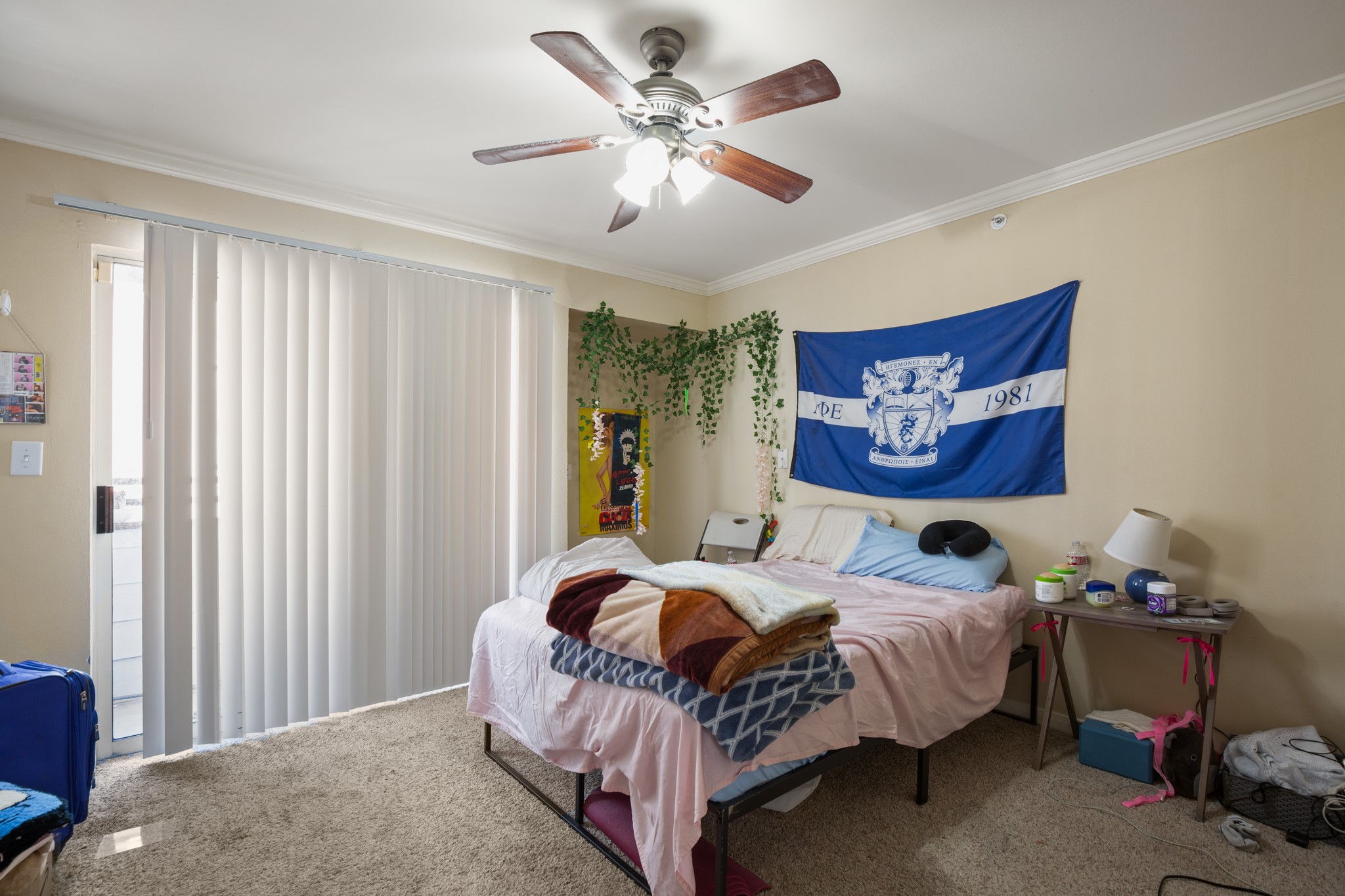 501 West 26th Street, Unit 304 Austin, TX 78705 - Photo 11 of 14 a bedroom with a bed and a chandelier