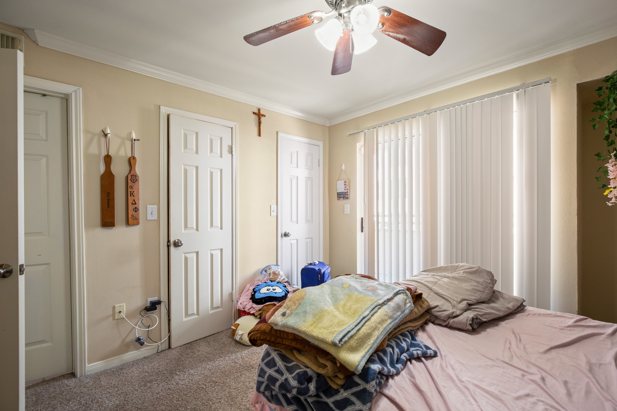 501 West 26th Street, Unit 304 Austin, TX 78705 - Photo 12 of 14 a bedroom with a bed and a chandelier