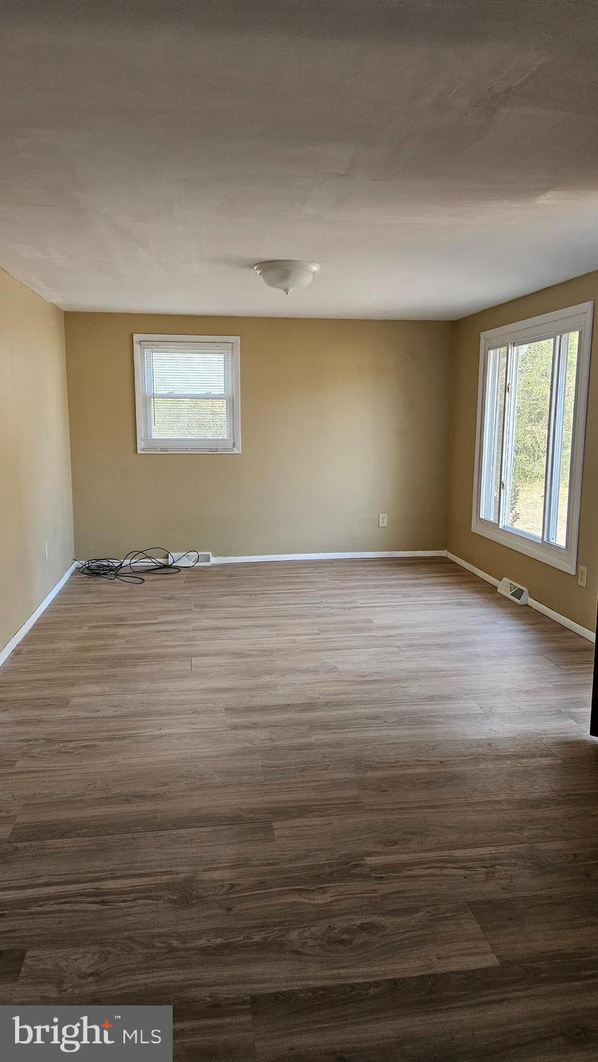 16506 Ridge Road King George, VA 22485 - Photo 2 of 15 an empty room with wooden floor and windows