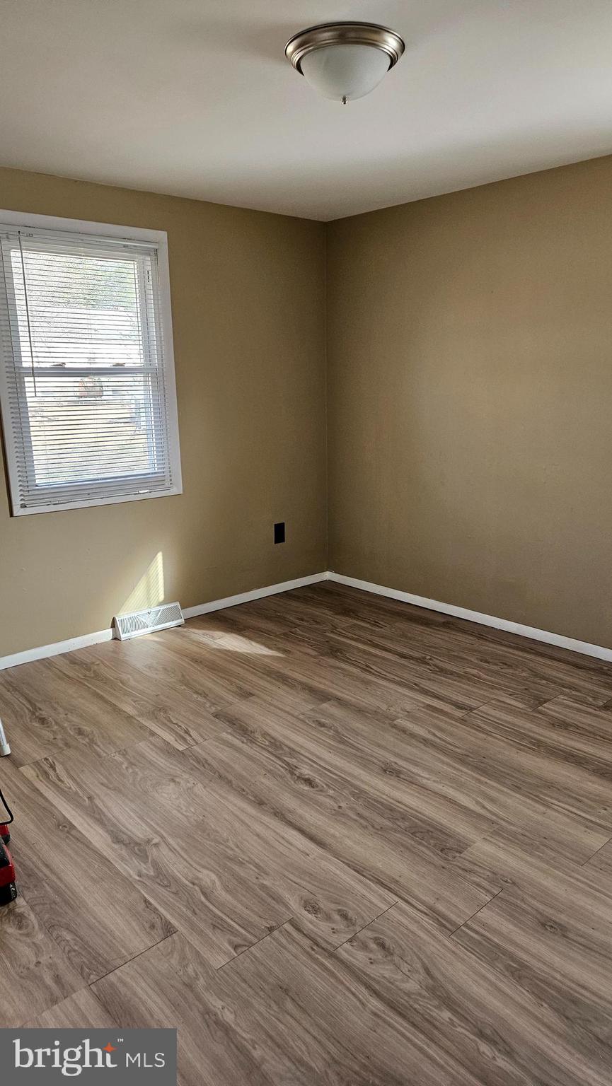 16506 Ridge Road King George, VA 22485 - Photo 3 of 15 an empty room with wooden floor and windows