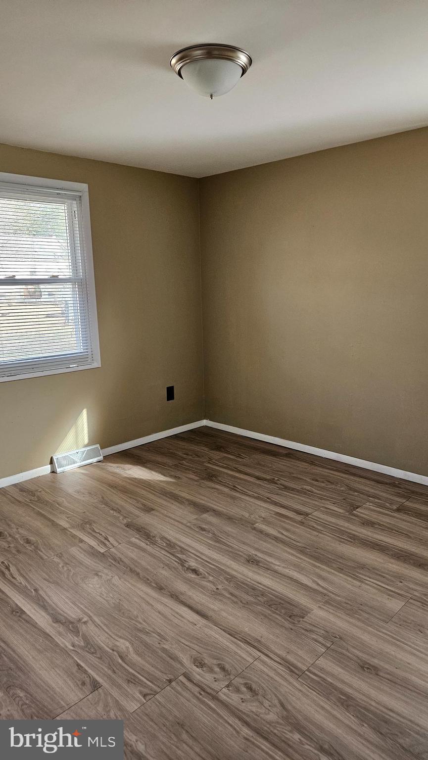 16506 Ridge Road King George, VA 22485 - Photo 4 of 15 an empty room with wooden floor and windows
