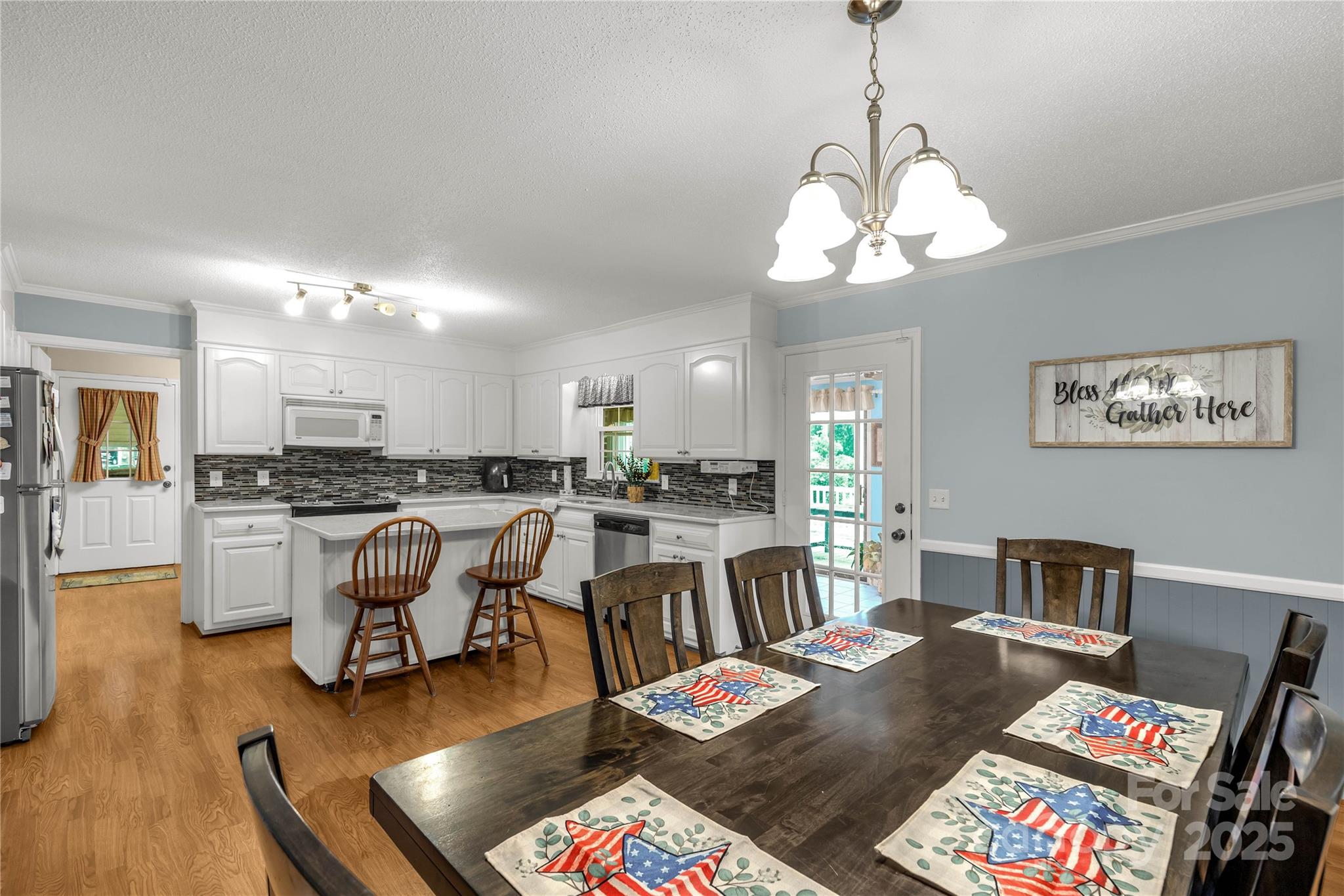 1162 East Doc Garris Road Lancaster, SC 29720 - Photo 8 of 31 a very nice looking living room with a dining table and paintings on the wall