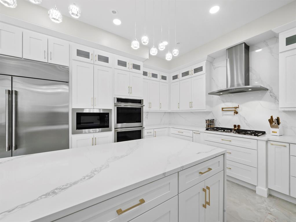 635 Jungle Queen Way Longboat Key, FL 34228 - Photo 16 of 55 a kitchen with cabinets and stainless steel appliances