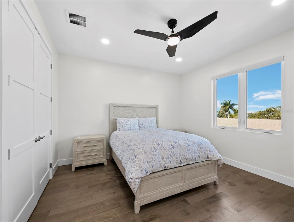 635 Jungle Queen Way Longboat Key, FL 34228 - Photo 34 of 55 a bedroom with a bed and a window