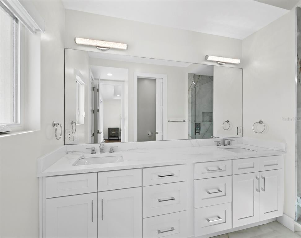 635 Jungle Queen Way Longboat Key, FL 34228 - Photo 37 of 55 a bathroom with a sink and a mirror