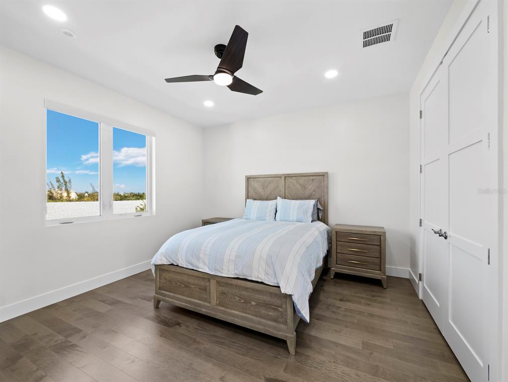 635 Jungle Queen Way Longboat Key, FL 34228 - Photo 38 of 55 a bedroom with a bed and a ceiling fan