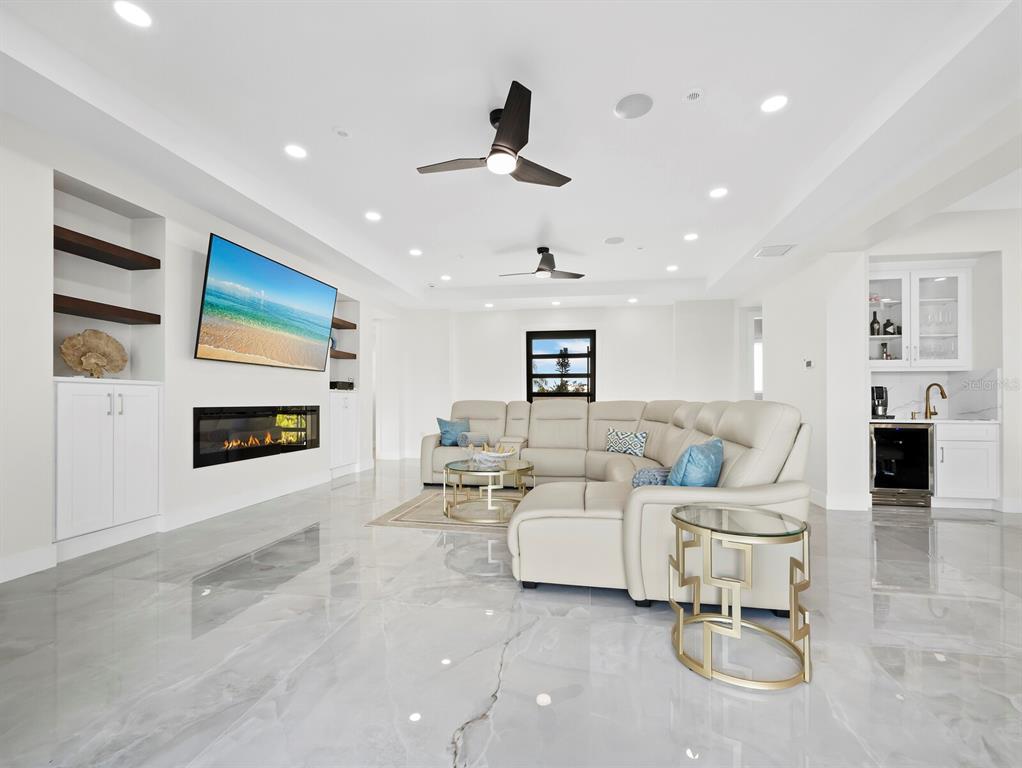 635 Jungle Queen Way Longboat Key, FL 34228 - Photo 10 of 55 a living room with furniture and a fireplace