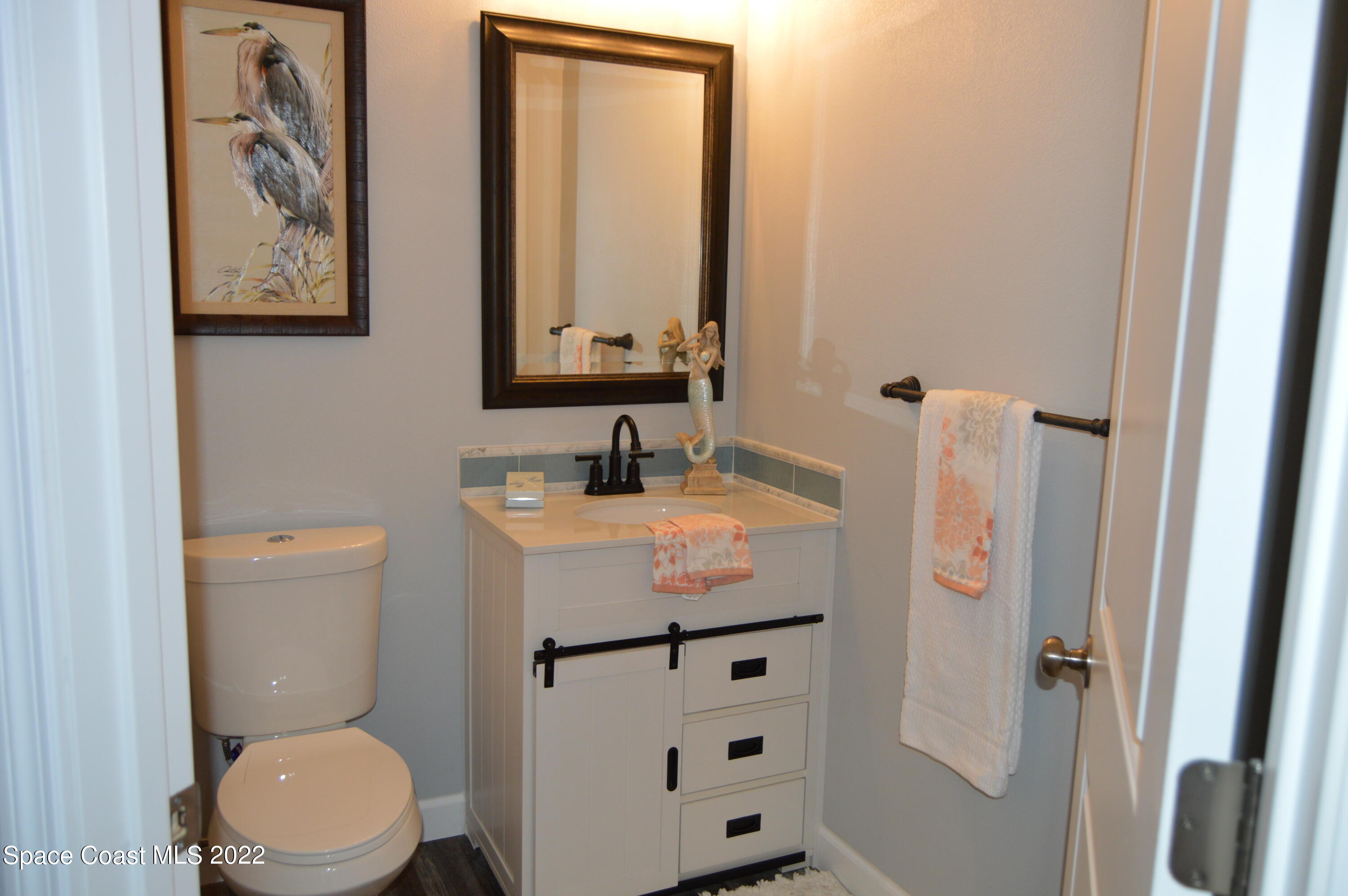 3460 Carter Road Mims, FL 32754 - Photo 13 of 32 a bathroom with a sink a toilet and shower