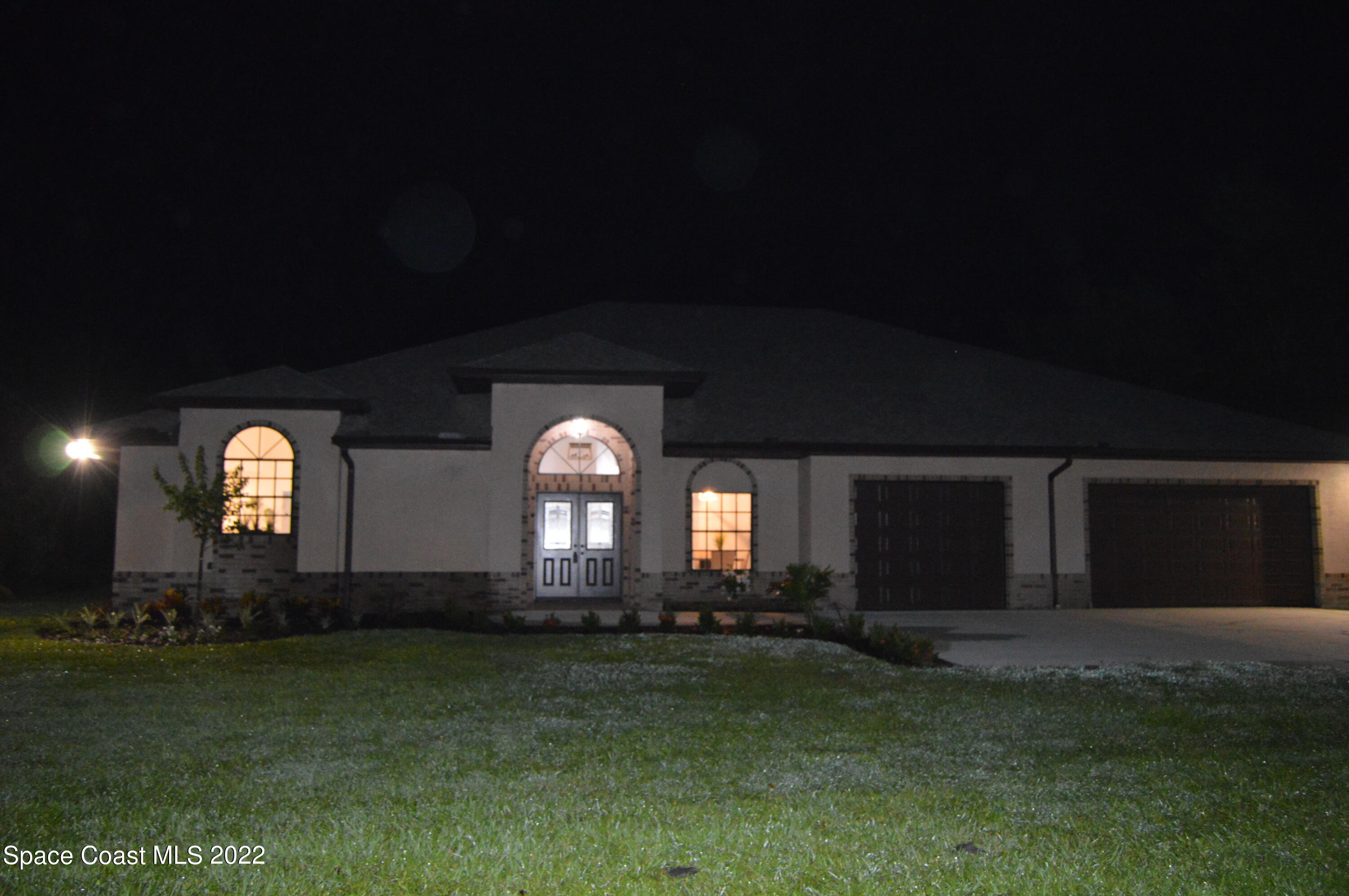 3460 Carter Road Mims, FL 32754 - Photo 17 of 32 a front view of a house with a garden