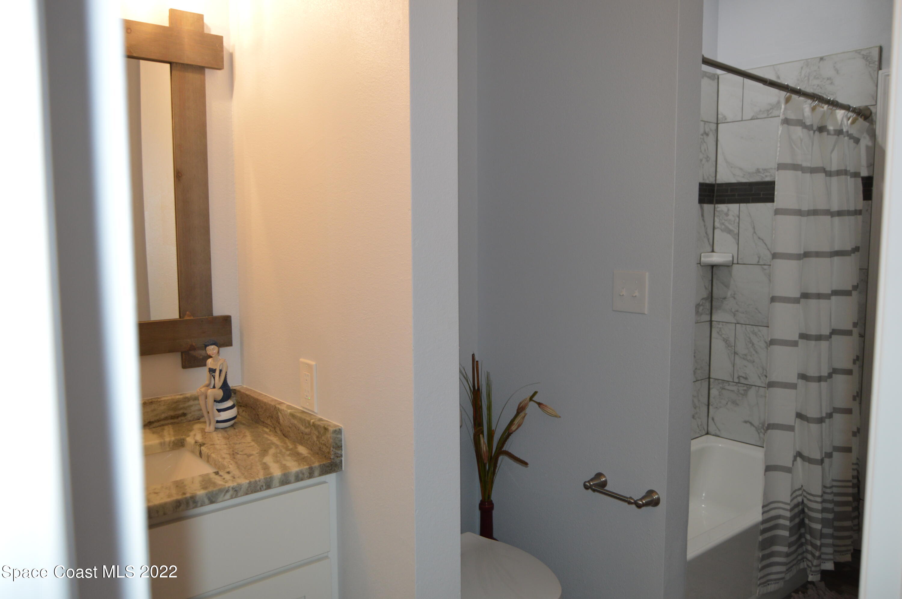 3460 Carter Road Mims, FL 32754 - Photo 23 of 32 a bathroom with a granite countertop sink toilet and shower
