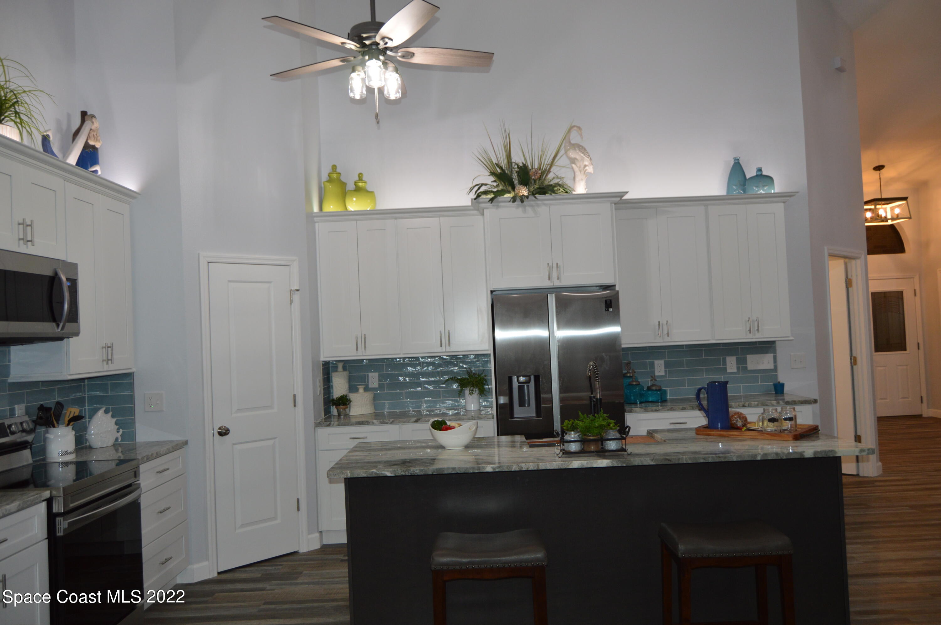 3460 Carter Road Mims, FL 32754 - Photo 27 of 32 a kitchen with counter top space cabinets and appliances