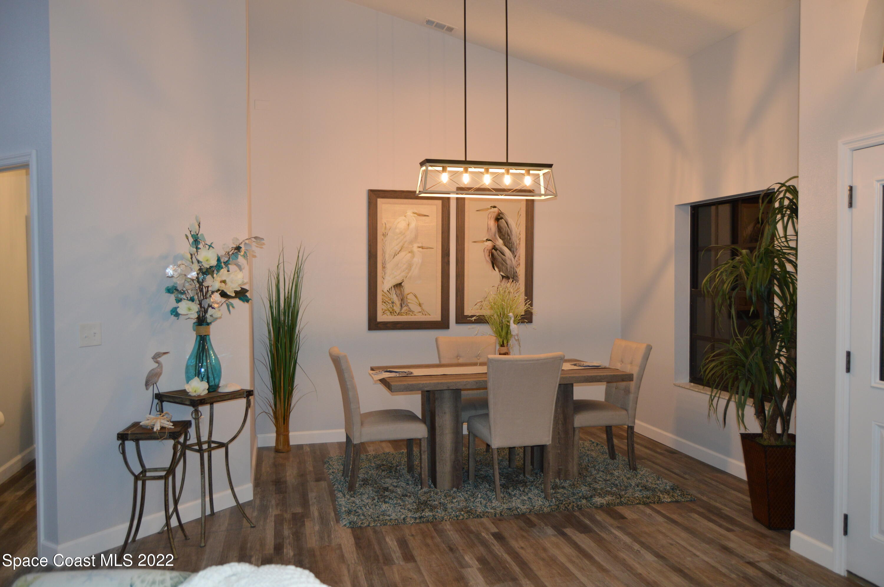 3460 Carter Road Mims, FL 32754 - Photo 4 of 32 a view of a dining room with furniture window and wooden floor