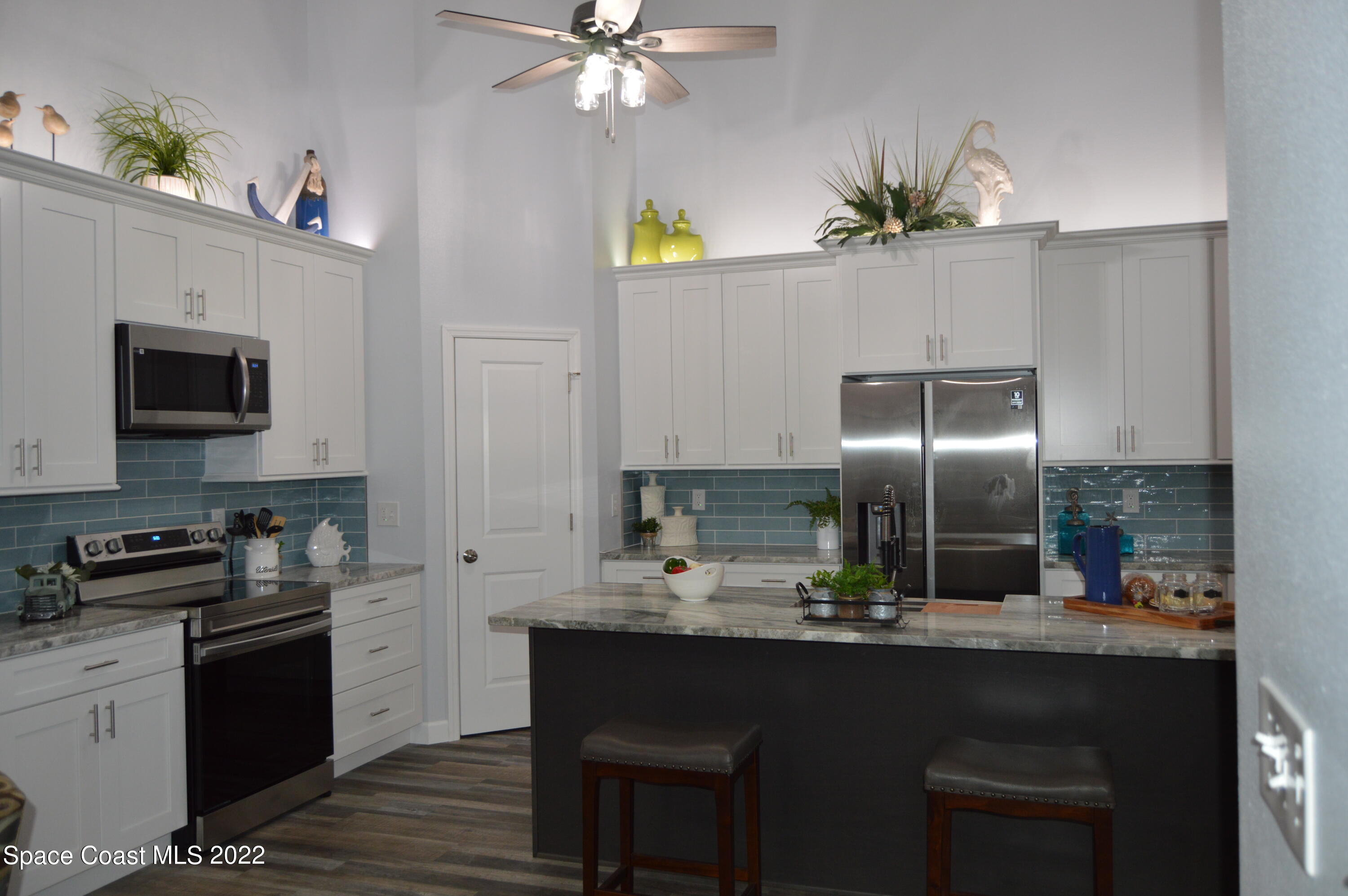 3460 Carter Road Mims, FL 32754 - Photo 5 of 32 a kitchen with stainless steel appliances granite countertop a sink a stove top oven a counter space and cabinets
