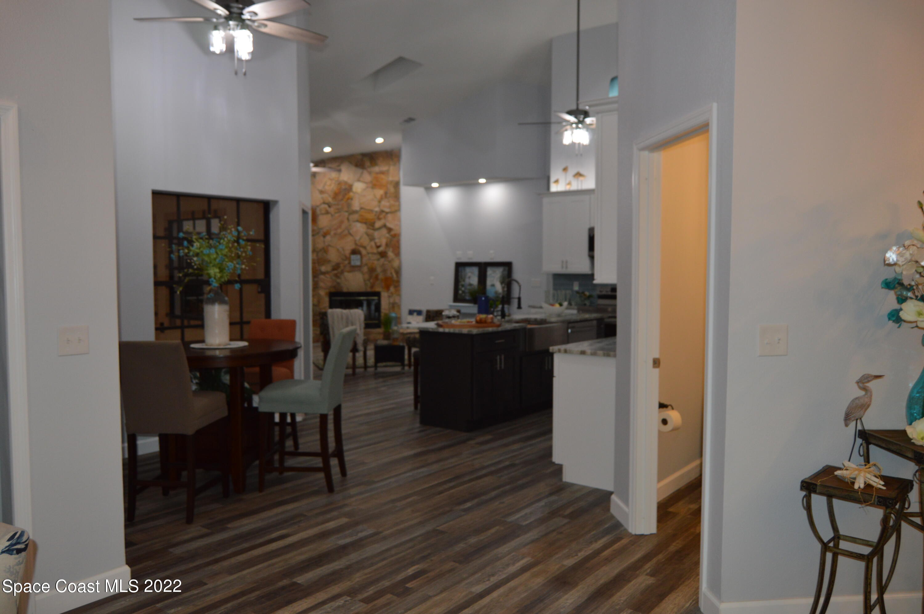 3460 Carter Road Mims, FL 32754 - Photo 7 of 32 a kitchen with a table chairs refrigerator and cabinets