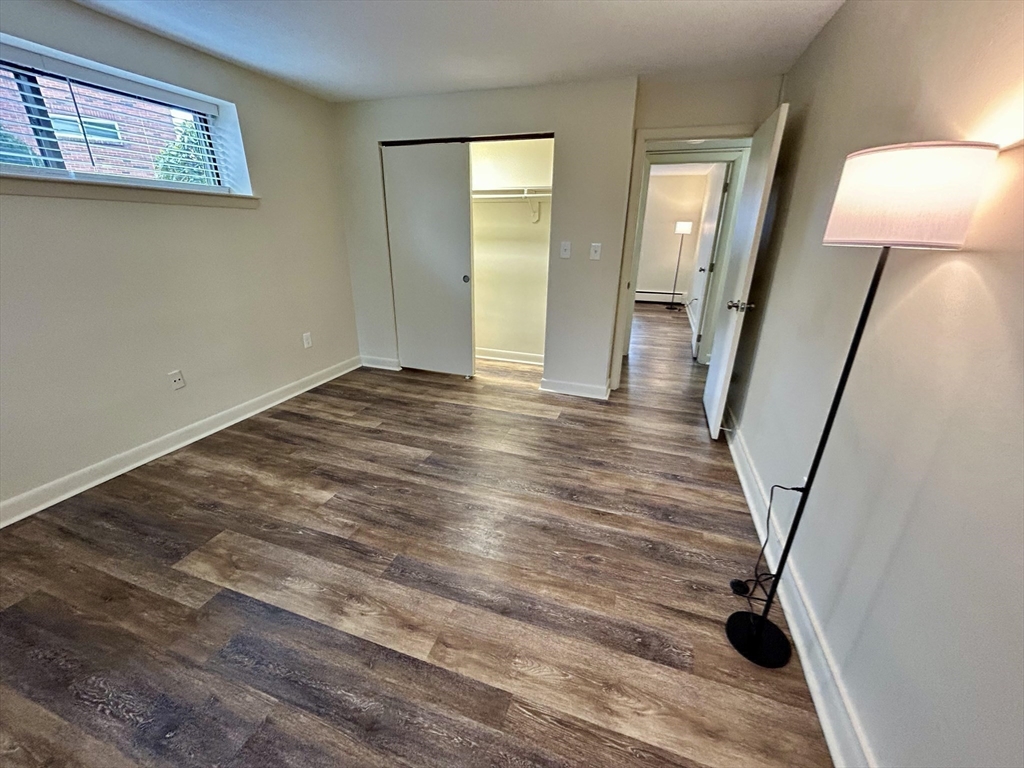 70 C Charles River Road, Unit 70C Waltham, MA 02453 - Photo 14 of 27 a view of empty room with wooden floor and fan