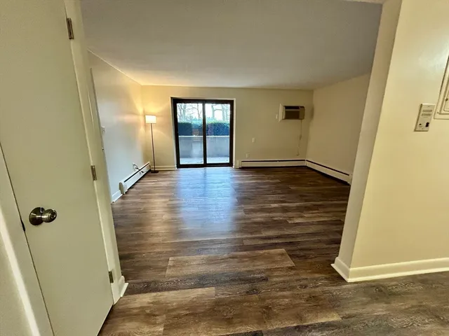 an empty room with wooden floor and closet