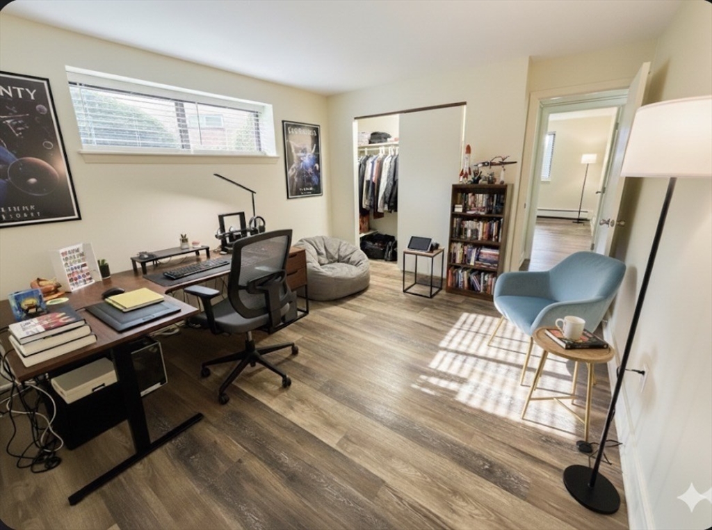 70 C Charles River Road, Unit 70C Waltham, MA 02453 - Photo 9 of 27 a living room with furniture a table and wooden floor