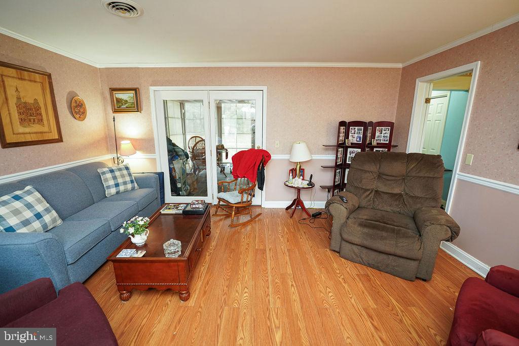 30332 Dagsboro Road Salisbury, MD 21804 - Photo 13 of 53 a living room with furniture and a wooden floor