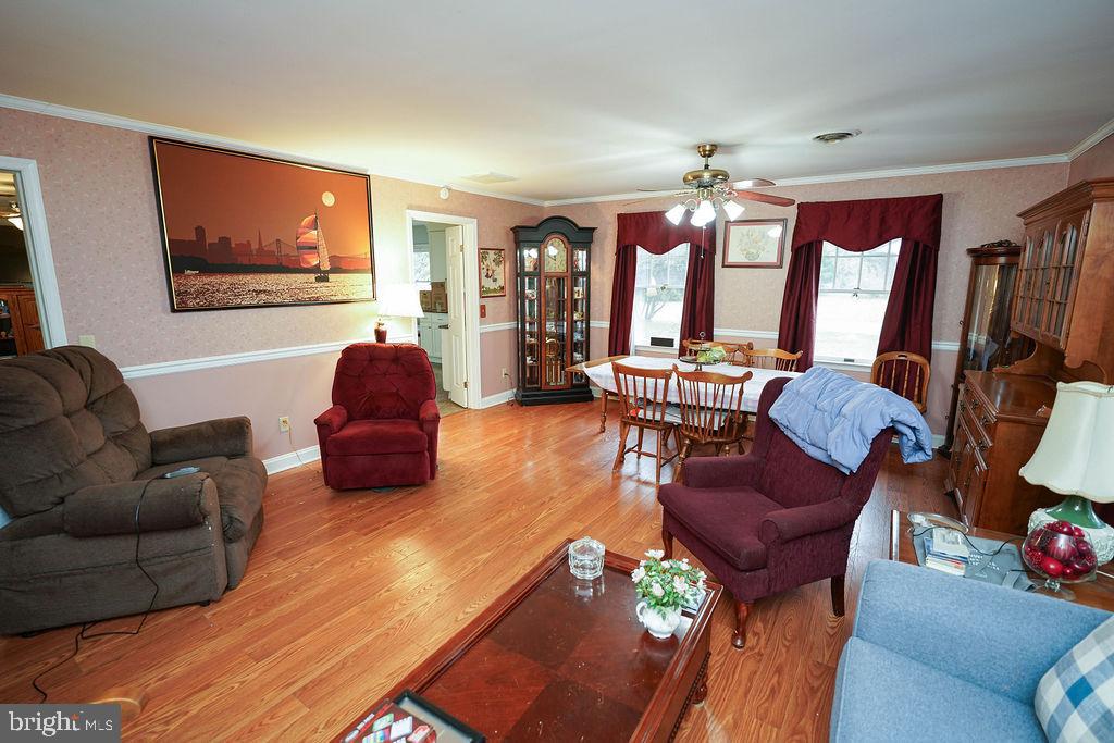 30332 Dagsboro Road Salisbury, MD 21804 - Photo 18 of 53 a living room with furniture a flat screen tv and a large window