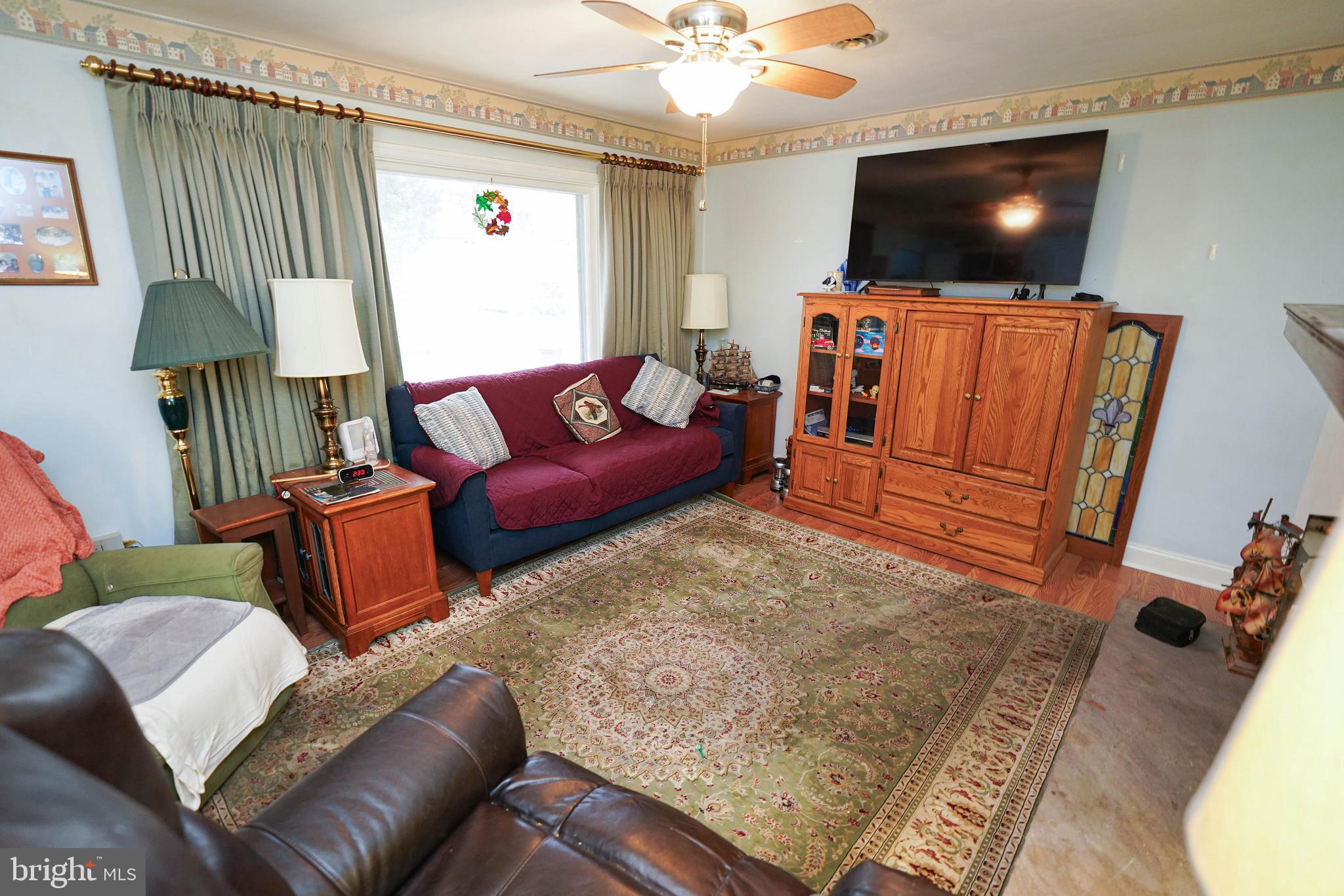 30332 Dagsboro Road Salisbury, MD 21804 - Photo 19 of 53 a living room with furniture and a flat screen tv