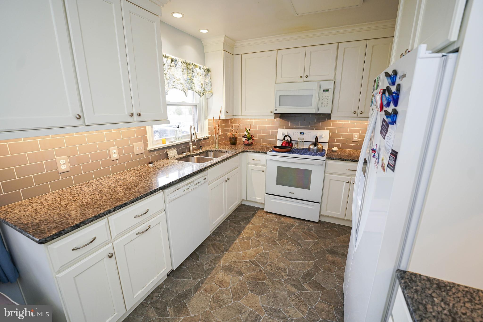 30332 Dagsboro Road Salisbury, MD 21804 - Photo 6 of 53 a kitchen with white cabinets and white appliances