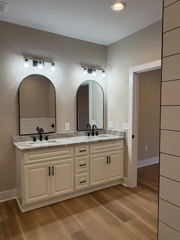 a view of a kitchen counter space a sink wooden floor and window