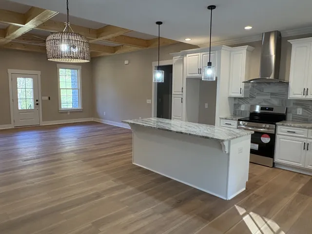 a bathroom with a granite countertop sink a mirror and a bathtub