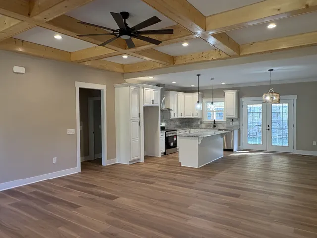 an empty room with closet and a ceiling fan