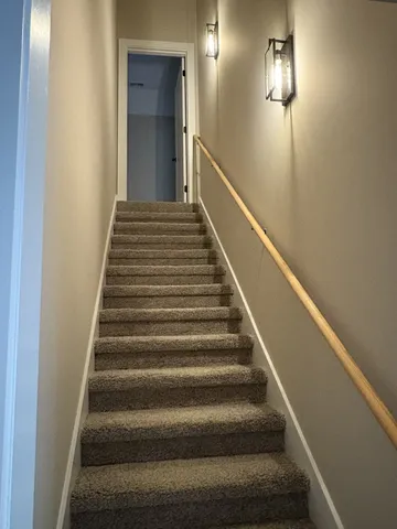 a bathroom with a granite countertop sink a mirror and shower