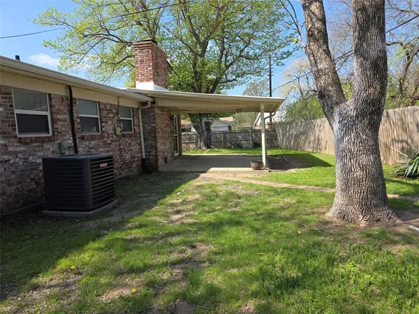 a backyard of a house with barbeque oven and seating space