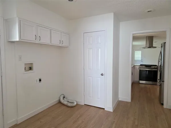a view of a kitchen with sink and wooden floor