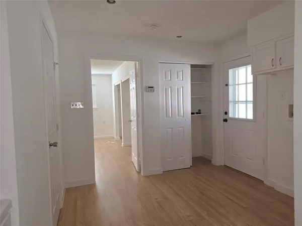 a view of a room with wooden floor and windows
