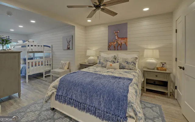 a bedroom with a large bed and a chandelier