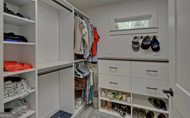 a spacious bedroom with a bed and large window
