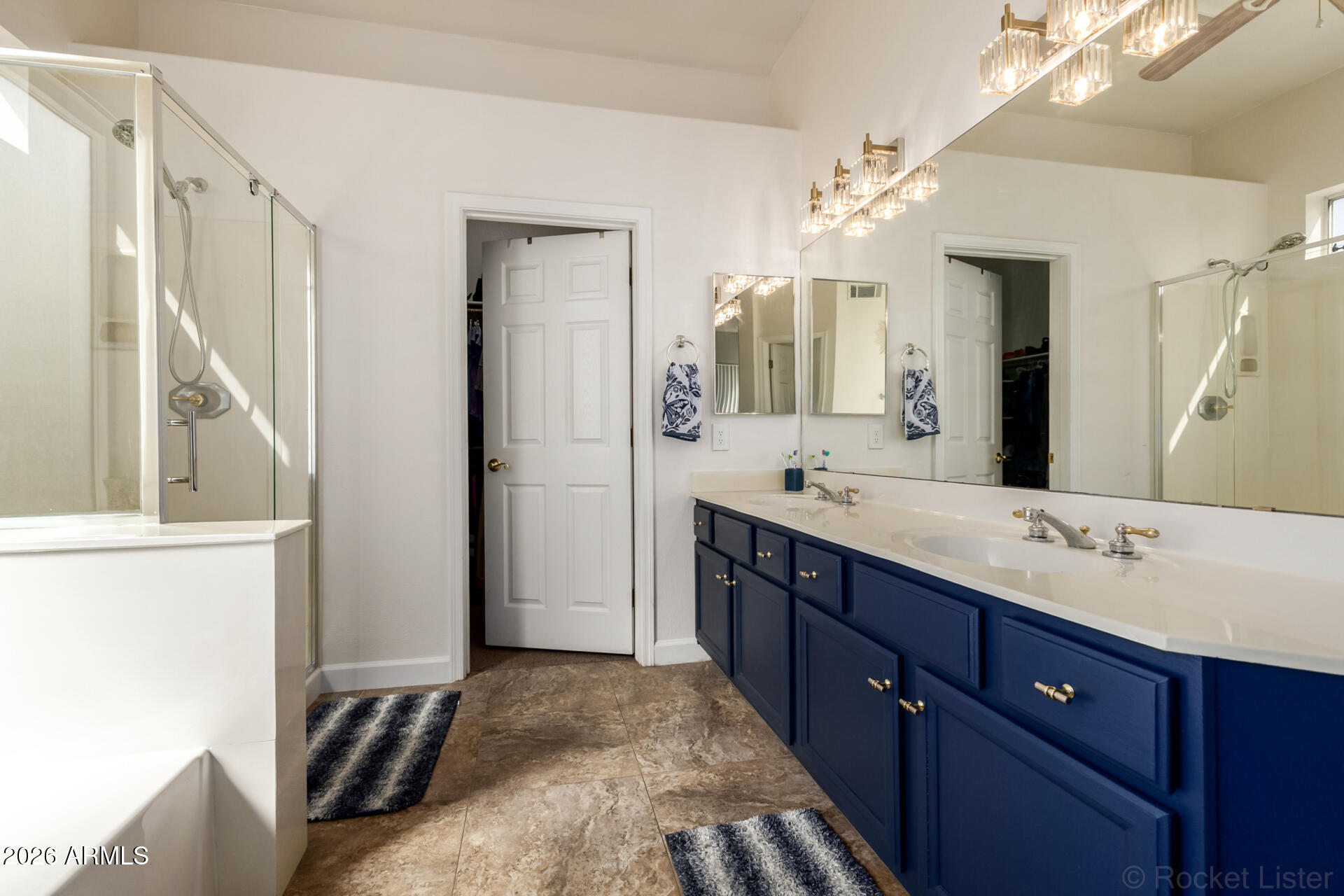 9545 East Inverness Circle Mesa, AZ 85209 - Photo 12 of 26 a spacious bathroom with a granite countertop sink a mirror and a shower