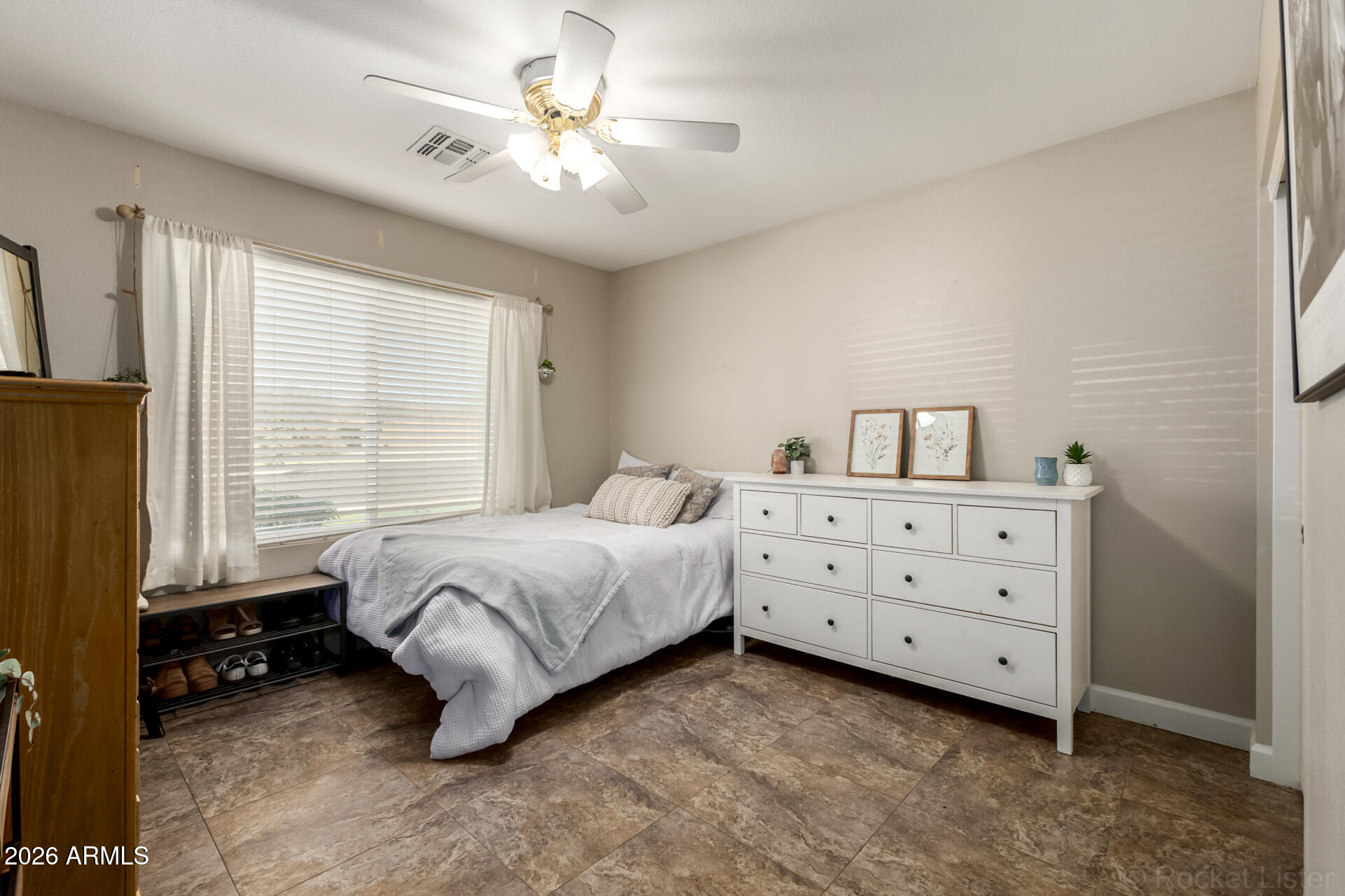 9545 East Inverness Circle Mesa, AZ 85209 - Photo 13 of 26 a spacious bedroom with a bed and a window