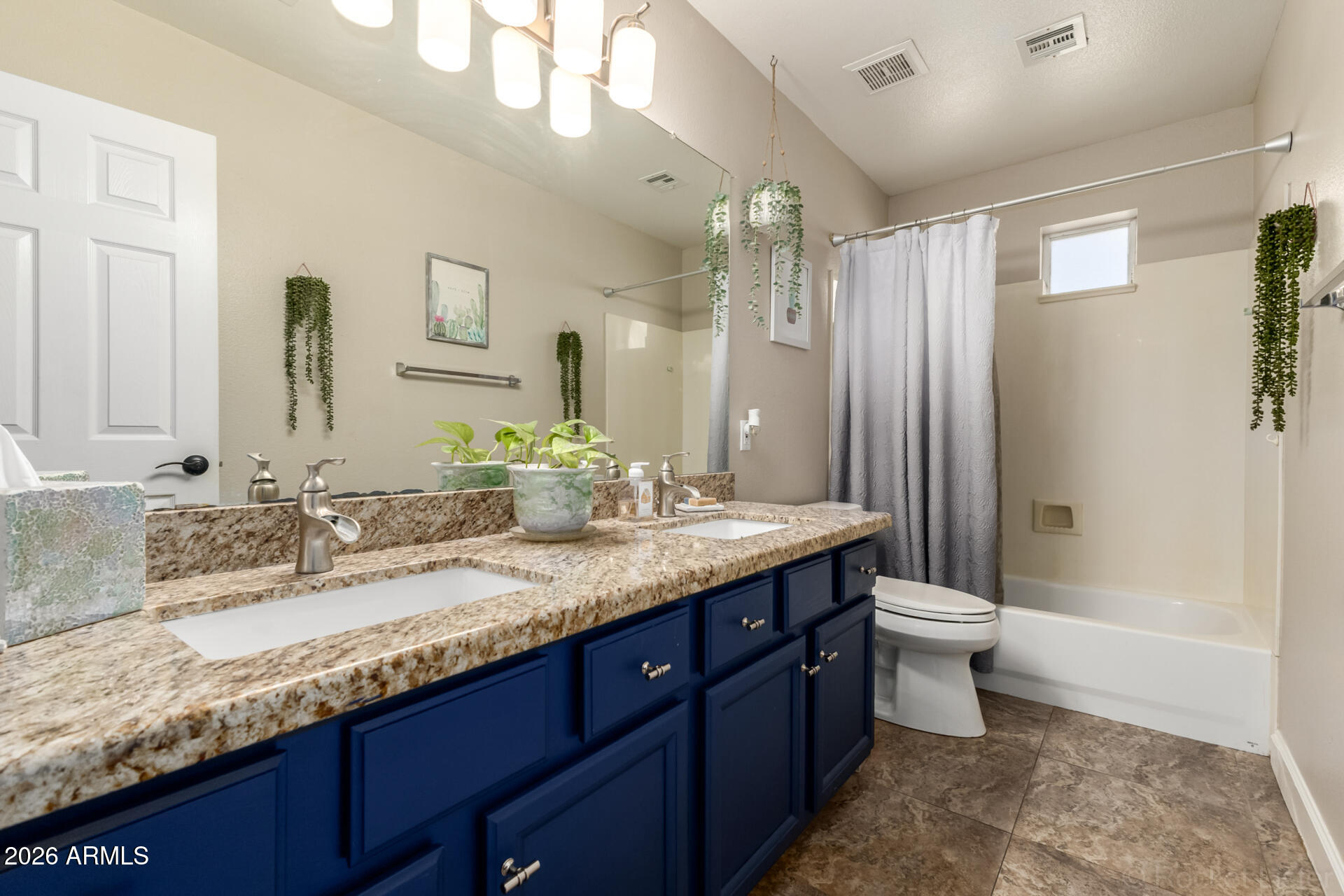 9545 East Inverness Circle Mesa, AZ 85209 - Photo 17 of 26 a bathroom with a granite countertop sink toilet and shower