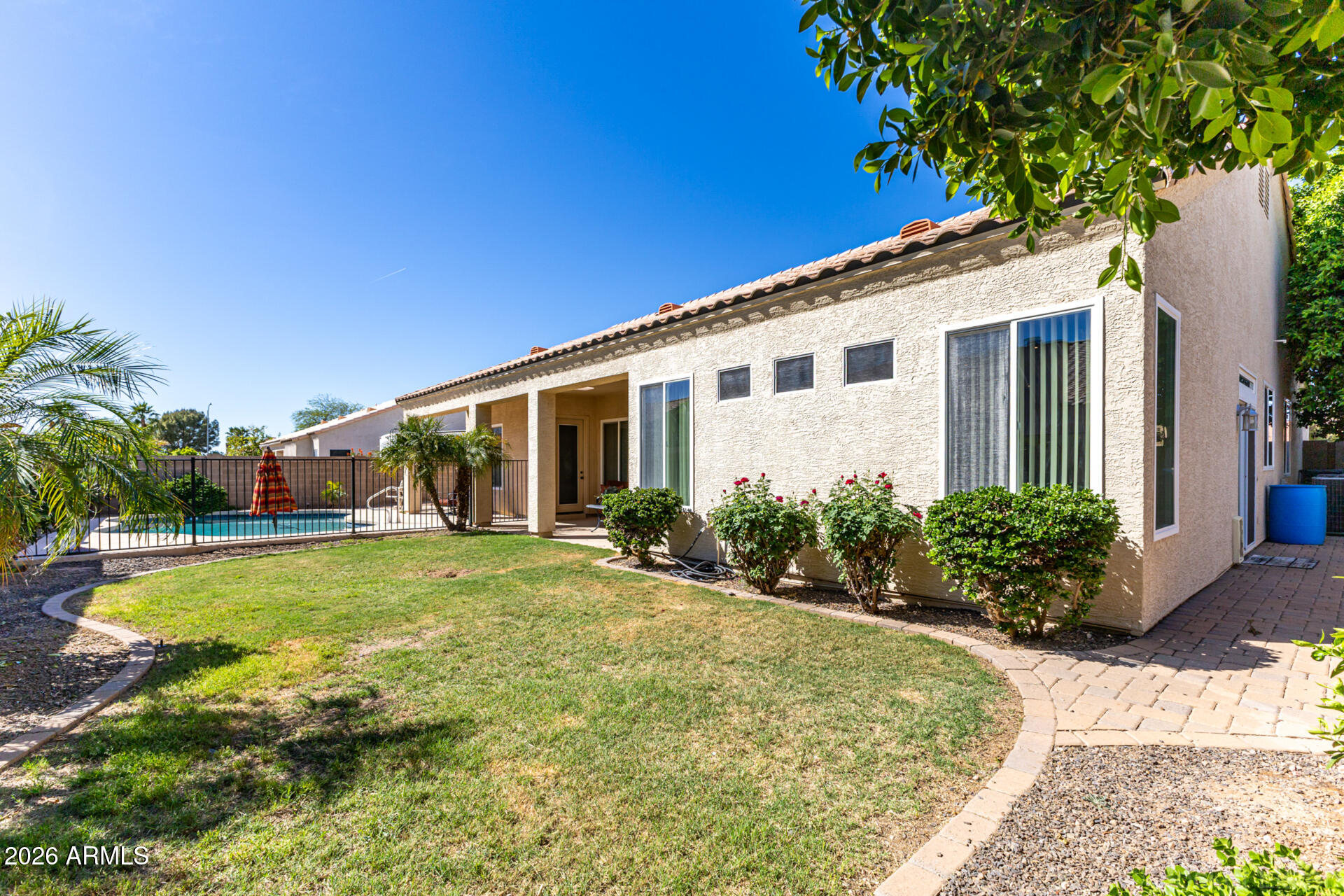 9545 East Inverness Circle Mesa, AZ 85209 - Photo 20 of 26 a view of a house with pool and garden