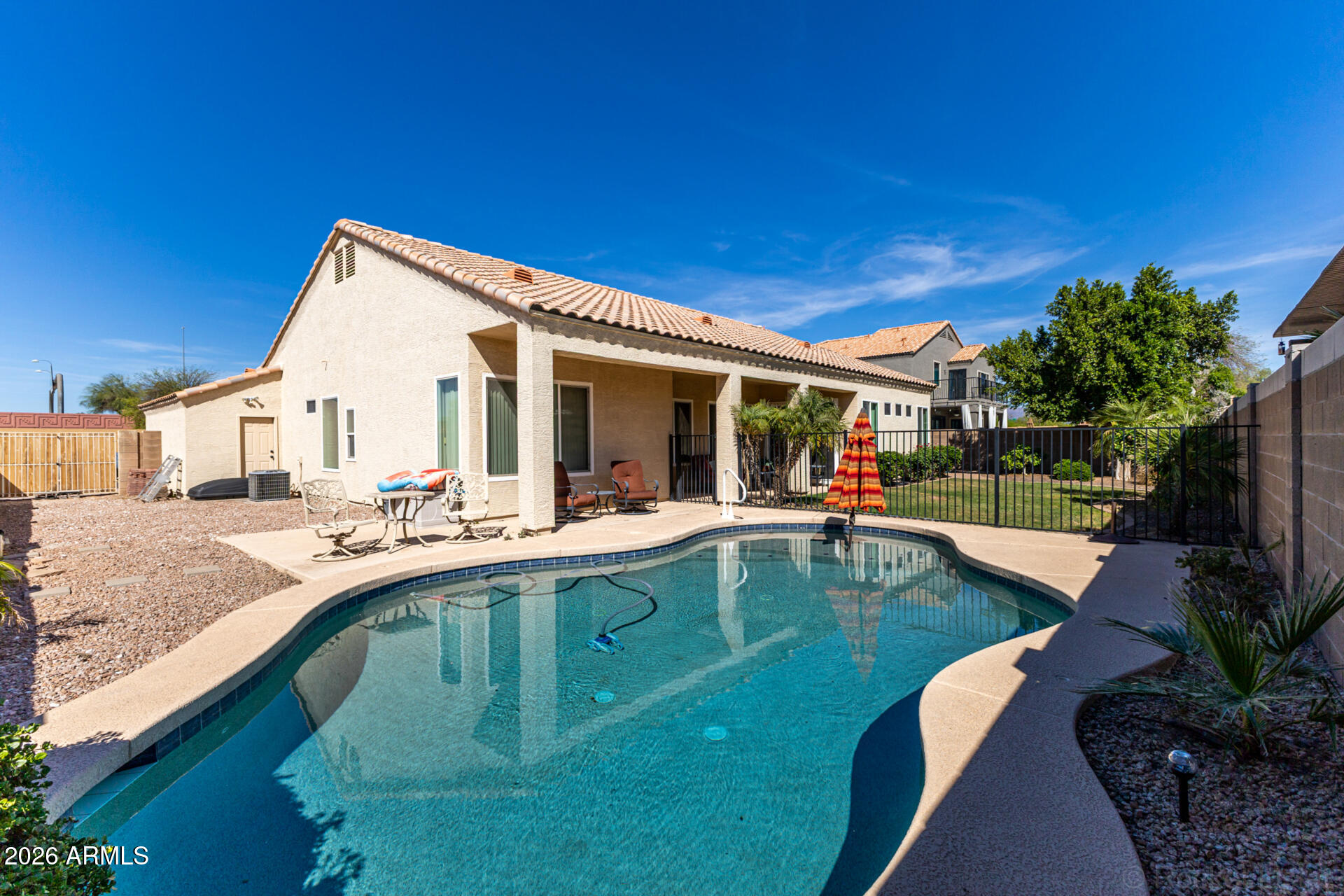 9545 East Inverness Circle Mesa, AZ 85209 - Photo 26 of 26 a view of swimming pool with outdoor seating and house in the background
