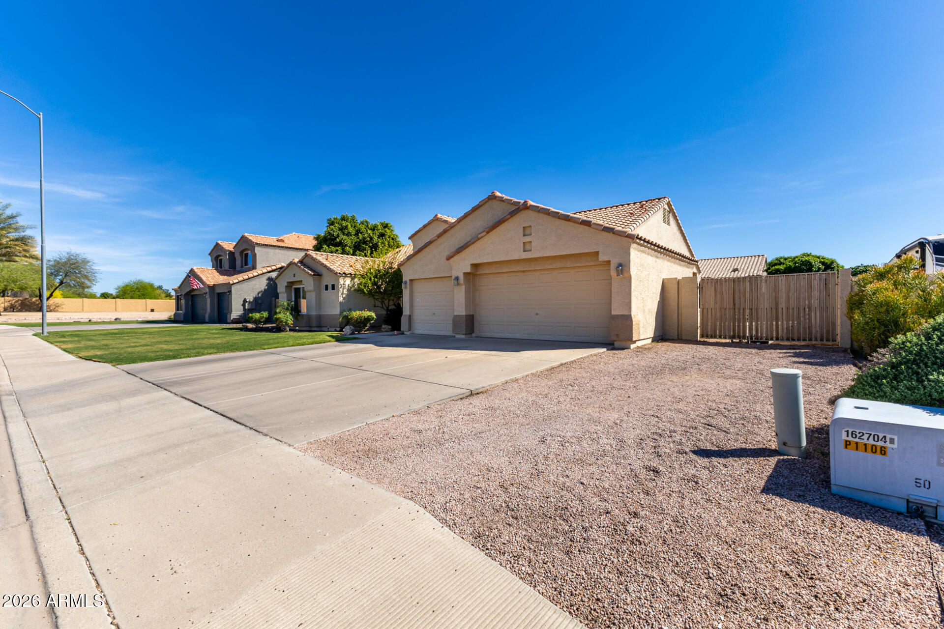 9545 East Inverness Circle Mesa, AZ 85209 - Photo 3 of 26 a front view of a house with a yard and garage