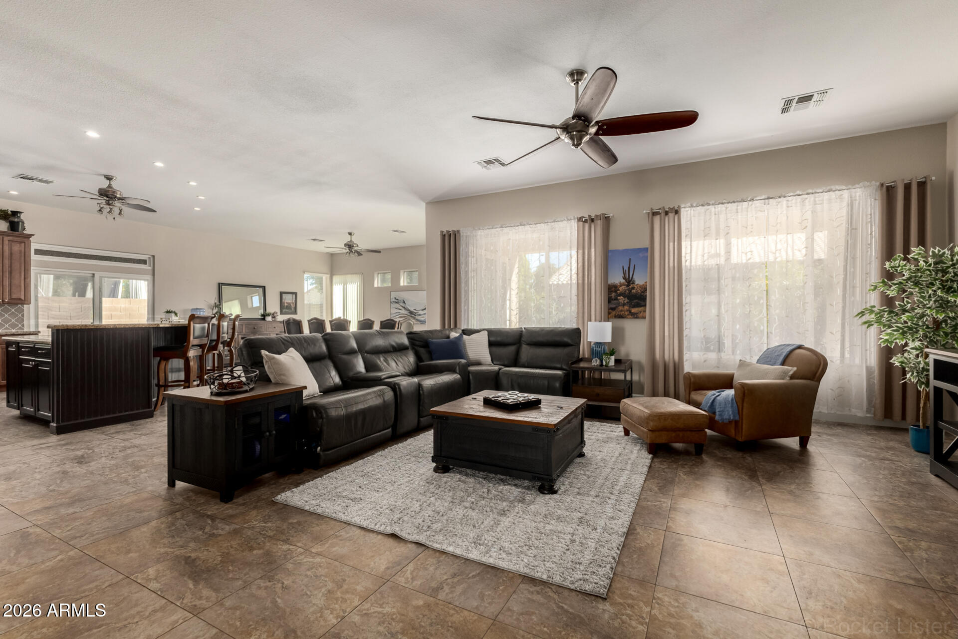 9545 East Inverness Circle Mesa, AZ 85209 - Photo 4 of 26 a living room with furniture and a large window