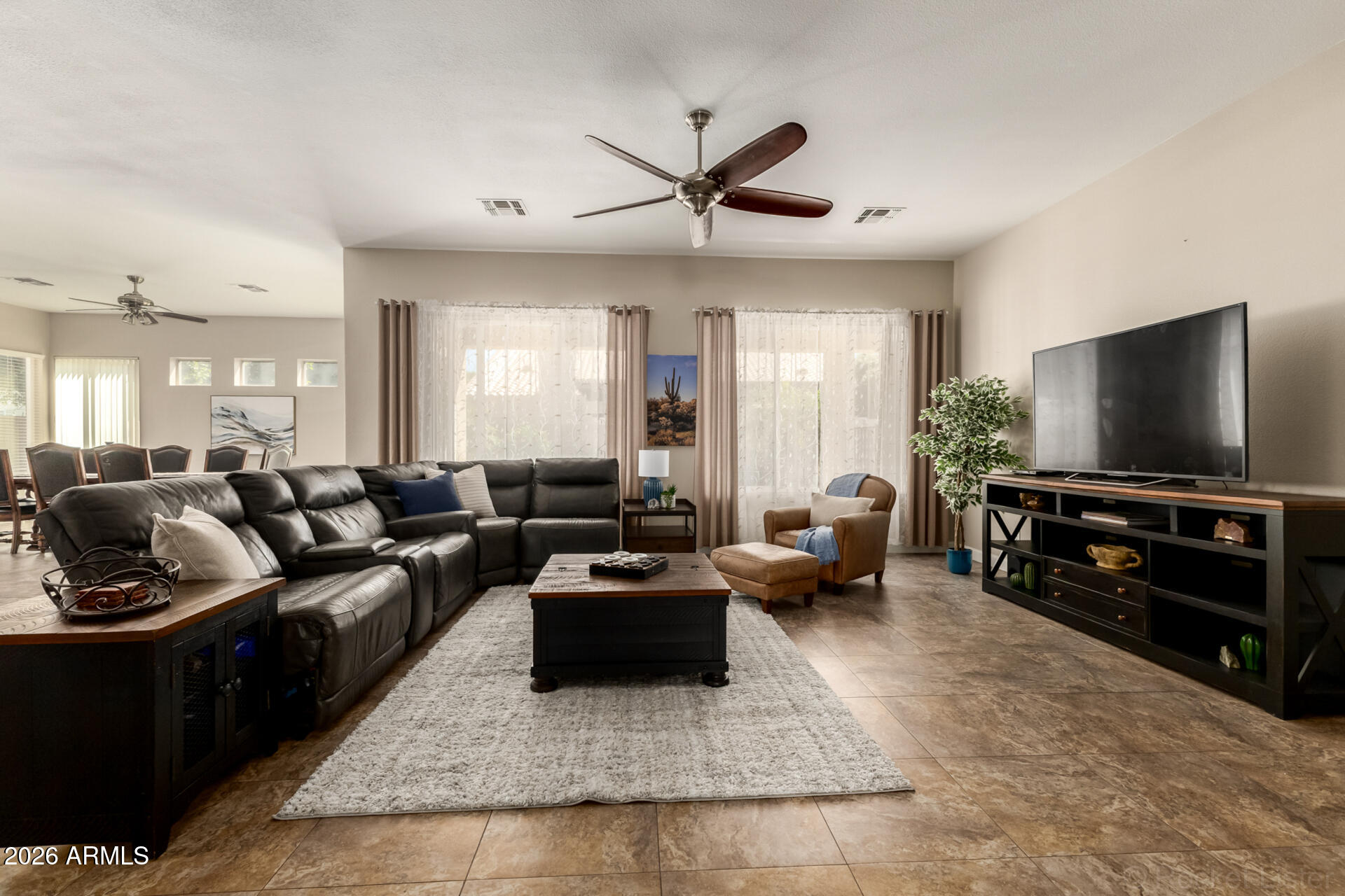 9545 East Inverness Circle Mesa, AZ 85209 - Photo 5 of 26 a living room with furniture and a flat screen tv