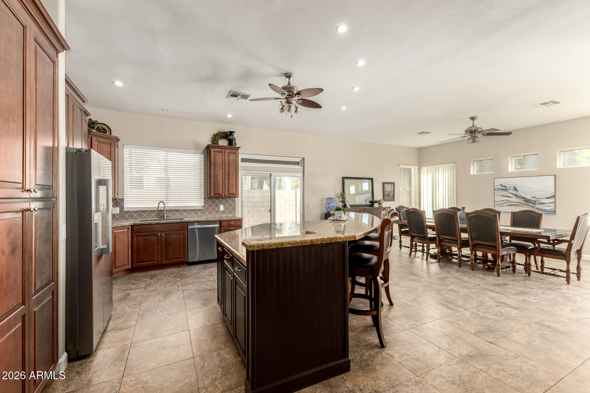 9545 East Inverness Circle Mesa, AZ 85209 - Photo 7 of 26 a large kitchen with lots of counter and chairs