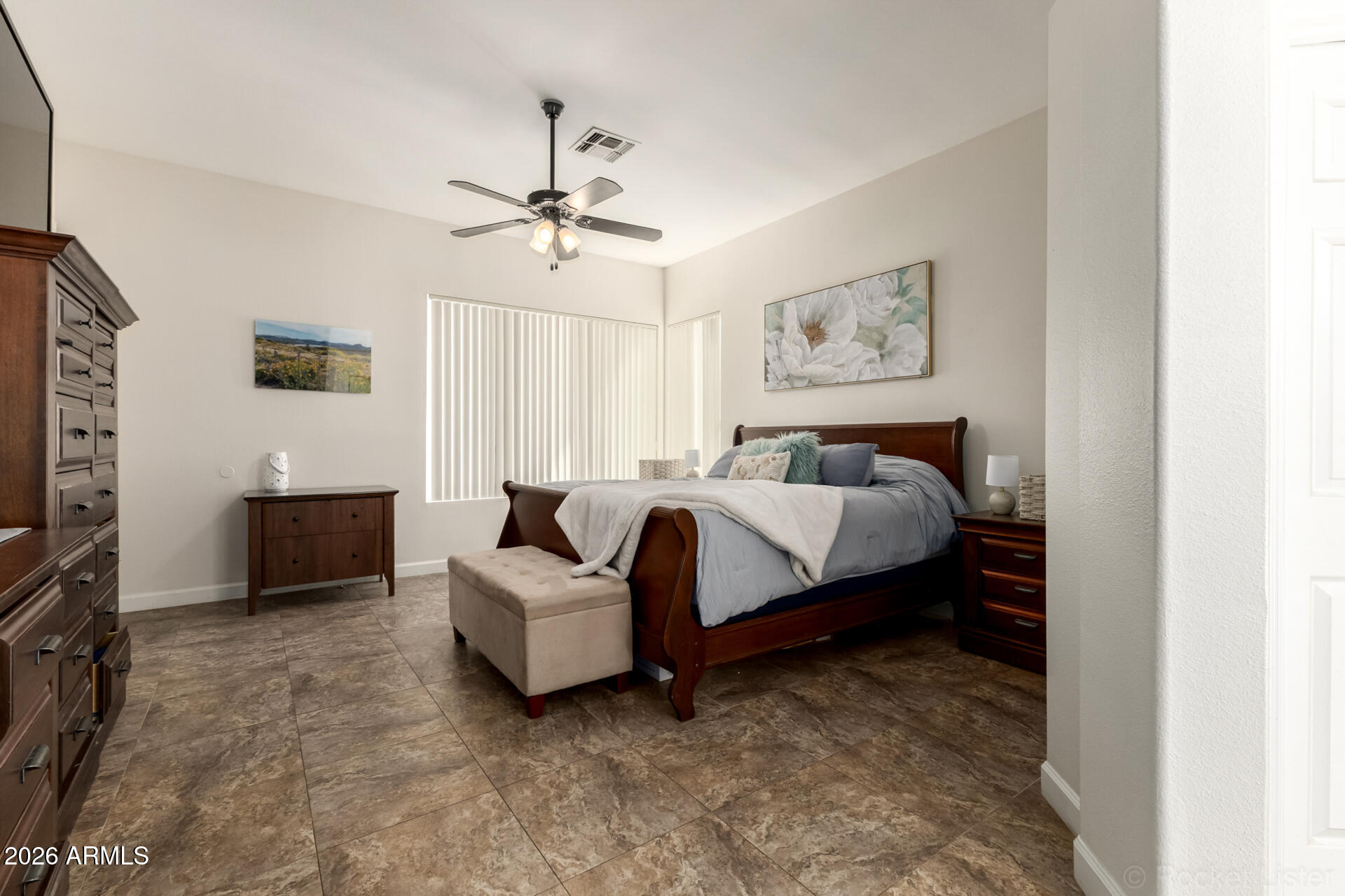9545 East Inverness Circle Mesa, AZ 85209 - Photo 10 of 26 a spacious bedroom with a bed and a flat screen tv