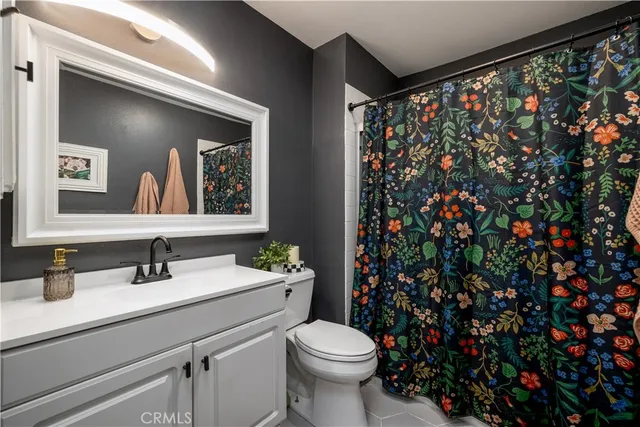 a bathroom with a sink toilet and mirror