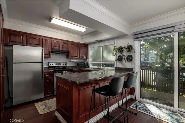 a kitchen with kitchen island a counter top space a sink appliances and cabinets