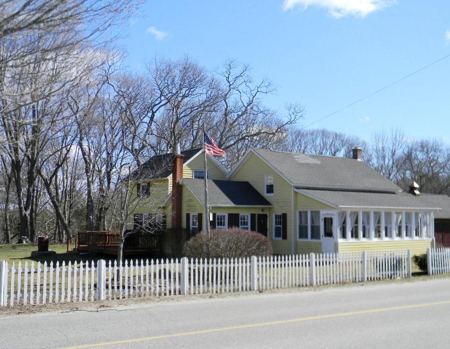 a front view of a house with a iron gate