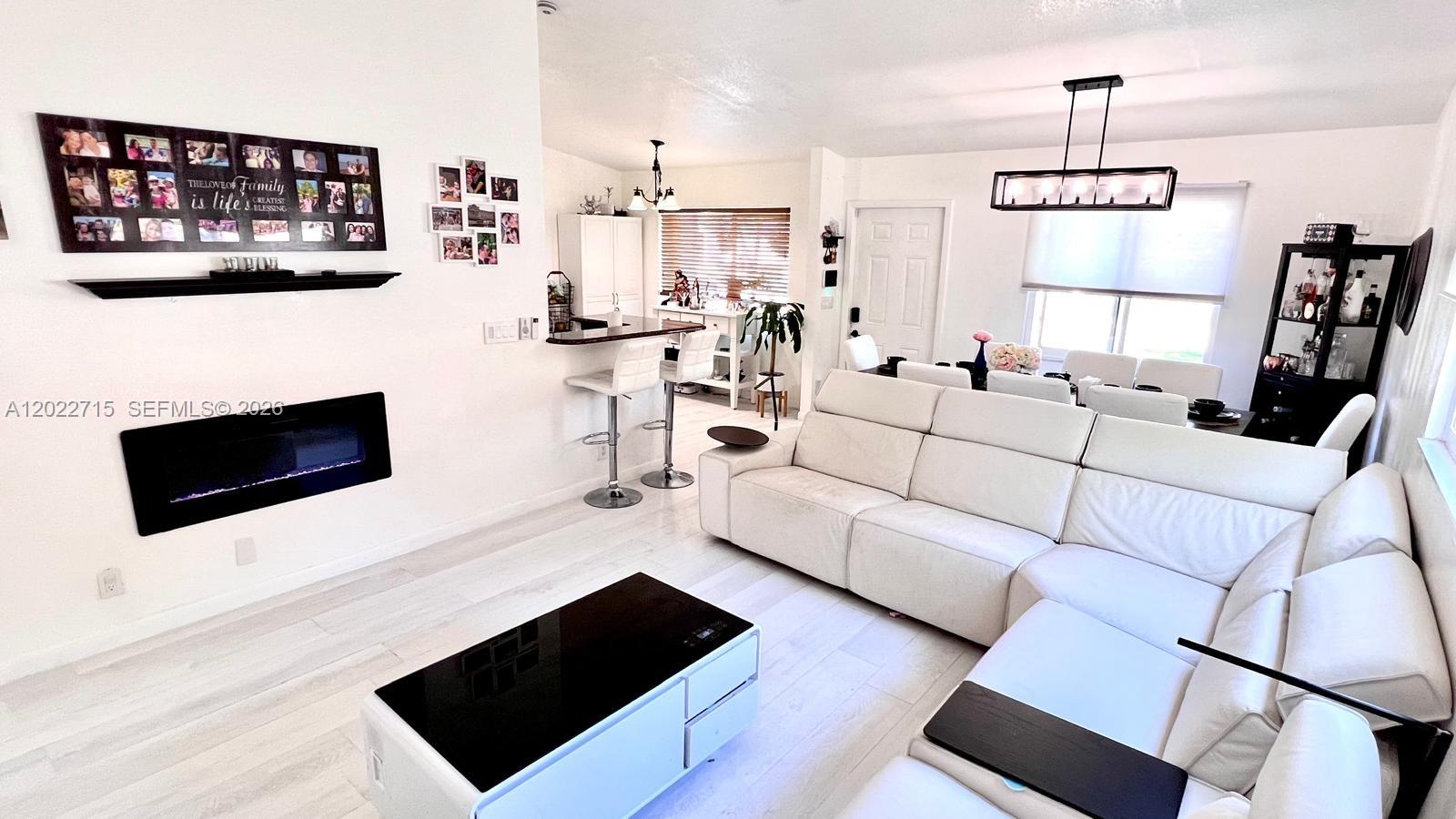 10669 Boca Entrada Boulevard Boca Raton, FL 33428 - Photo 2 of 19 a living room with furniture and a flat screen tv